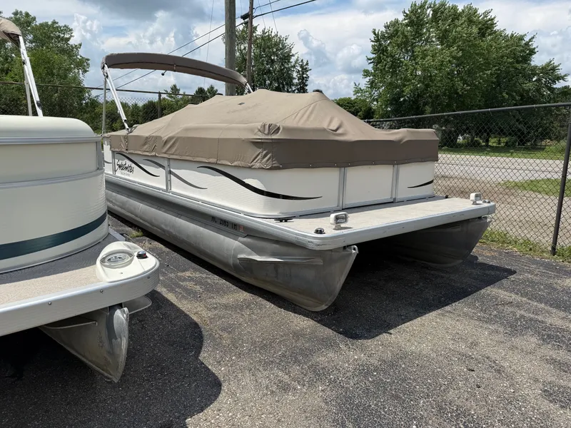 Slide: The Image of 2009 Godfrey Tuscany Series pontoon boat with cover, parked on asphalt. - 7