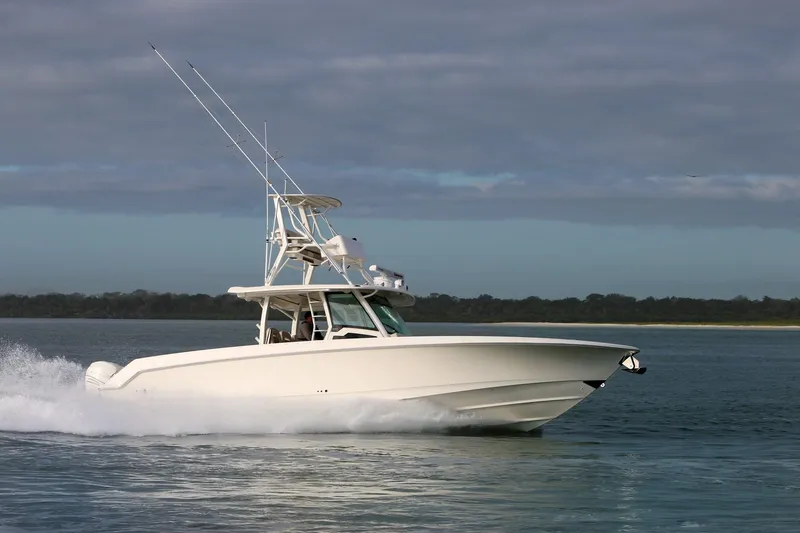 Slide: The Image of 2023 Boston Whaler 380 Outrage cruising on calm waters. - 1