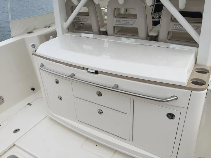 Slide: The Image of Boston Whaler 380 Outrage 2023 boat interior with storage drawers and seating. - 10