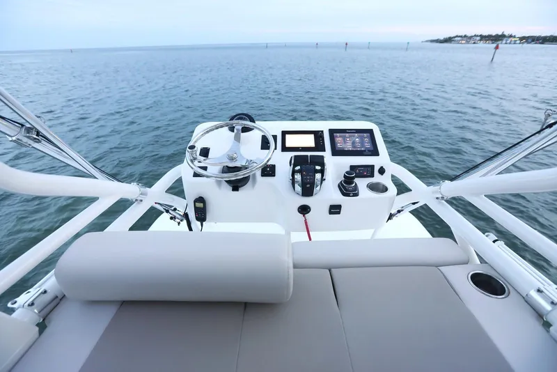 Slide: The Image of 2023 Boston Whaler 380 Outrage helm station overlooking calm waters. - 21