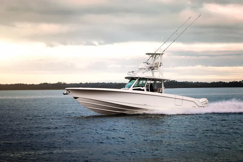 Slide: The Image of 2023 Boston Whaler 380 Outrage cruising on open water at sunset. - 4