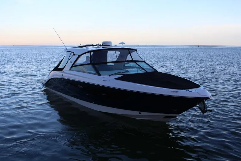 Slide: The Image of 2023 Sea Ray SLX 400 boat on calm water at sunset. - 3