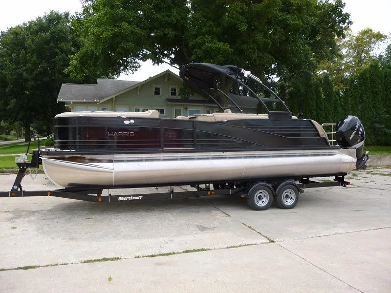 Slide: The Image of 2016 Harris Grand Mariner SEL 250 pontoon boat on trailer in driveway. - 0