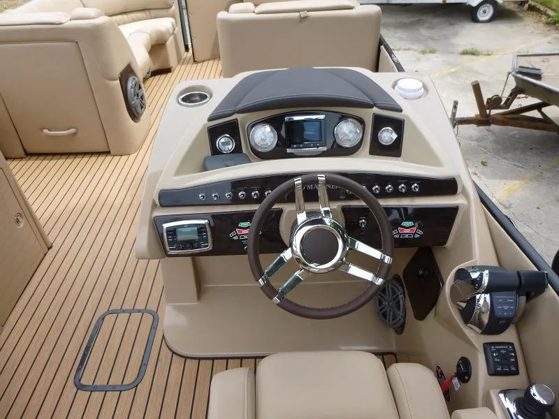 Slide: The Image of 2016 Harris Grand Mariner SEL 250 boat dashboard with steering wheel and control panel. - 3
