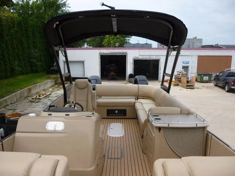 Slide: The Image of 2016 Harris Grand Mariner SEL 250 pontoon boat with beige interior and black canopy. - 4