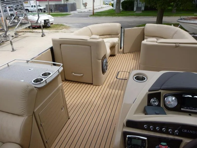 Slide: The Image of 2016 Harris Grand Mariner SEL 250 boat interior with beige seating and wooden flooring. - 6