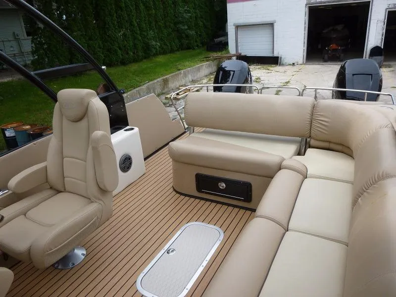 Slide: The Image of 2016 Harris Grand Mariner SEL 250 boat interior with beige seating and wood flooring. - 8