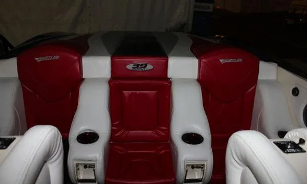 Slide: The Image of 2025 Hustler 39 Rockit boat interior with red and white leather seats. - 4