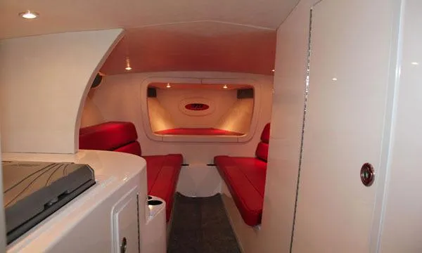 Slide: The Image of Interior of 2025 Hustler 39 Rockit boat with red seating and modern design. - 5
