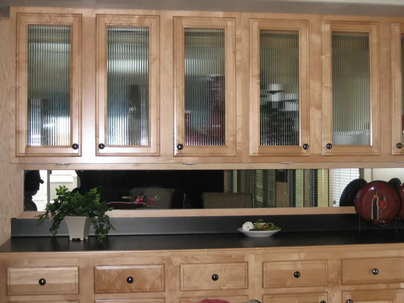 Slide: The Image of Wooden kitchen cabinets with glass doors in a 2006 Sumerset Seas The Day Trip 10. - 12