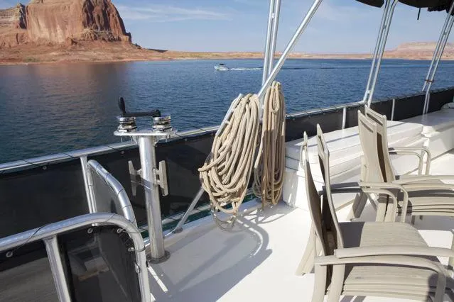 Slide: The Image of 2006 Sumerset Seas The Day Trip 10 boat deck with chairs, ropes, and scenic water view. - 3