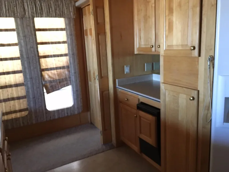 Slide: The Image of Wooden interior of 2002 Sharpe Just Because Week 30 houseboat kitchen. - 13