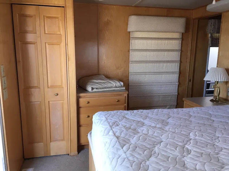 Slide: The Image of Cozy bedroom with wooden furniture, quilted bedspread, and soft lighting. Sharpe Just Because Week 30, 2002. - 4