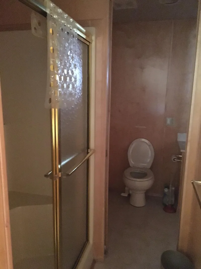 Slide: The Image of Bathroom with shower and toilet in a Sharpe Just Because Week 30, 2002 model. - 6