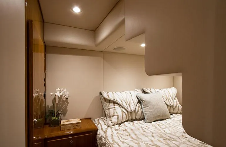 Slide: The Image of Luxurious bedroom interior of 2025 Viking 44 Open Express yacht with modern lighting. - 13