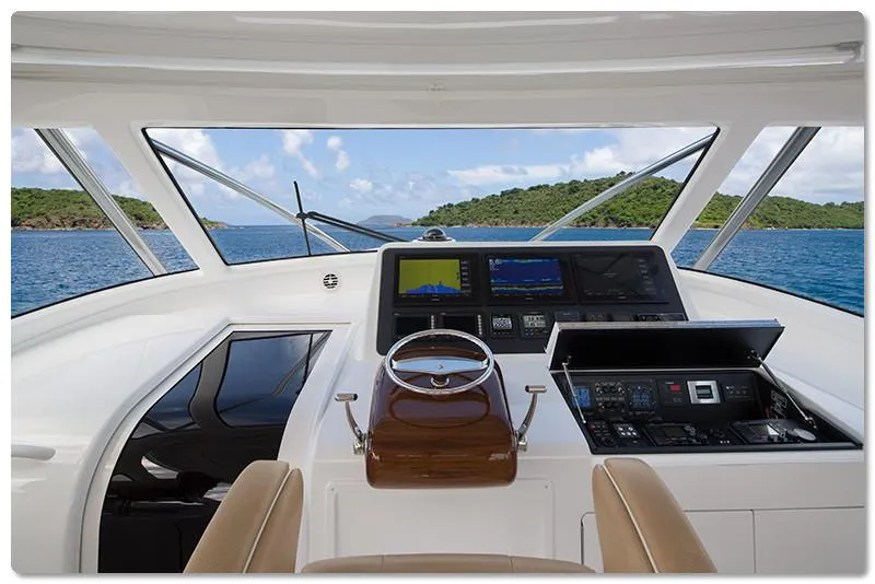 Slide: The Image of 2025 Viking 44 Open Express yacht helm with advanced navigation systems and scenic ocean view. - 5