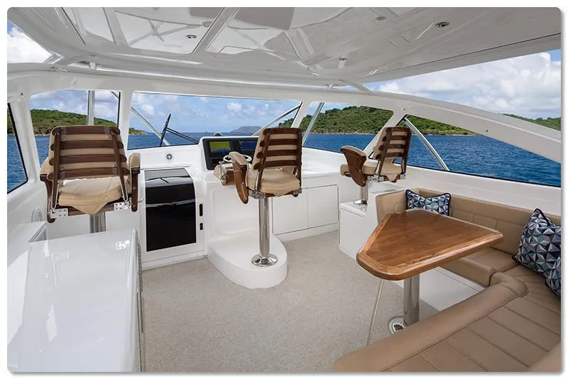 Slide: The Image of Interior of 2025 Viking 44 Open Express yacht with helm, seating, and ocean view. - 6