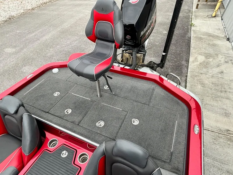 Slide: The Image of 2016 Ranger Z520 boat with red and black seating, spacious deck, and powerful motor. - 11