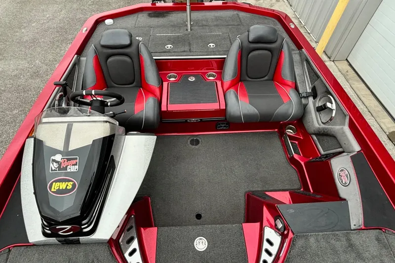 Slide: The Image of 2016 Ranger Z520 boat interior with red and black seats, steering console, and storage compartments. - 9