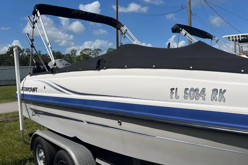 Slide: The Image of 2022 Starcraft Limited 2000 OB Fish boat on trailer, covered, with registration FL 5034 RK. - 2