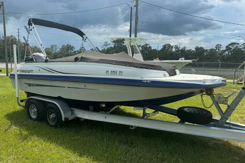 Slide: The Image of 2022 Starcraft Limited 2000 OB Fish boat on trailer, parked on grass. - 9