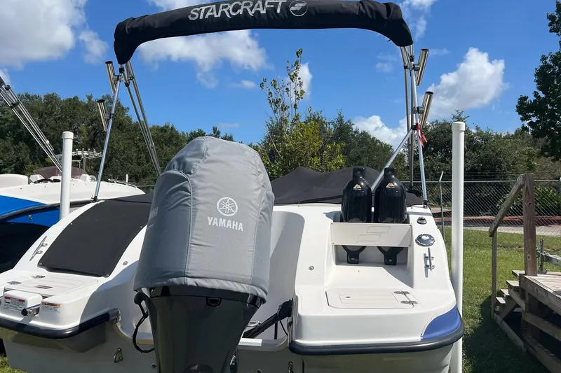 Slide: The Image of 2022 Starcraft Limited 2000 OB Fish boat with Yamaha engine, parked outdoors. - 4