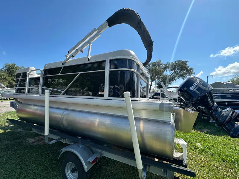 Slide: The Image of 2024 Sweetwater 1680 C pontoon boat on trailer with Suzuki outboard motor. - 4