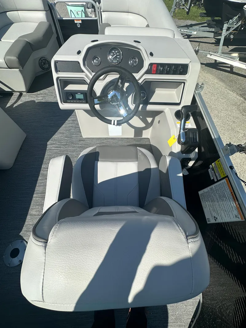 Slide: The Image of 2024 Sweetwater 1680 C boat cockpit with steering wheel and captain's chair. - 7