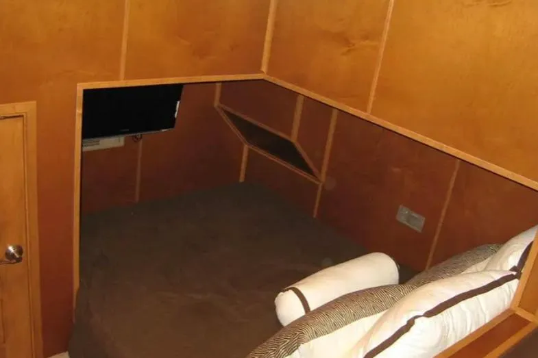 Slide: The Image of Cozy wooden interior of Bravada Helios Trip #7, featuring a bed and wall-mounted TV. - 14