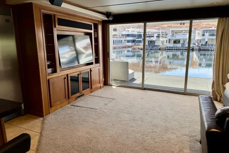 Slide: The Image of Luxurious Bravada Helios Trip #7 houseboat interior with large TV and waterfront view, 2012. - 18