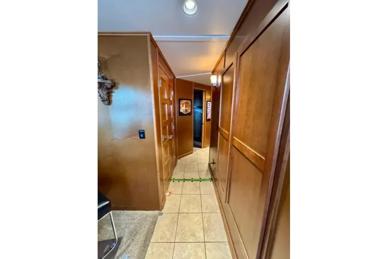 Slide: The Image of Hallway in 2012 Bravada Helios Trip #7, featuring wooden paneling and tiled floor. - 2