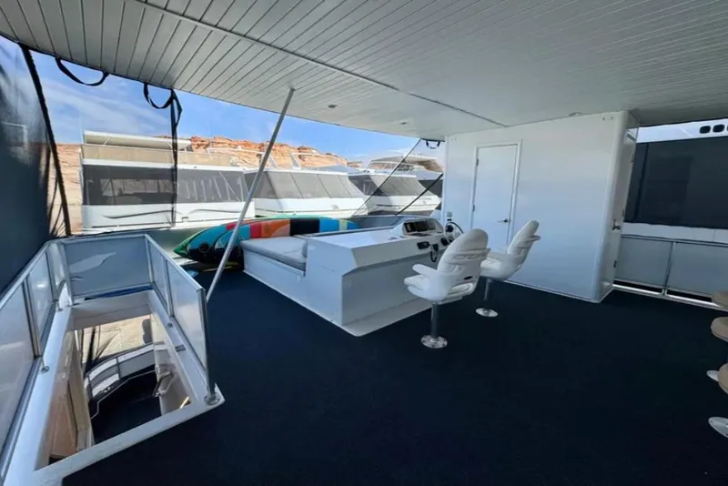 Slide: The Image of Spacious upper deck of 2012 Bravada Helios Trip #7 houseboat with seating and helm. - 22