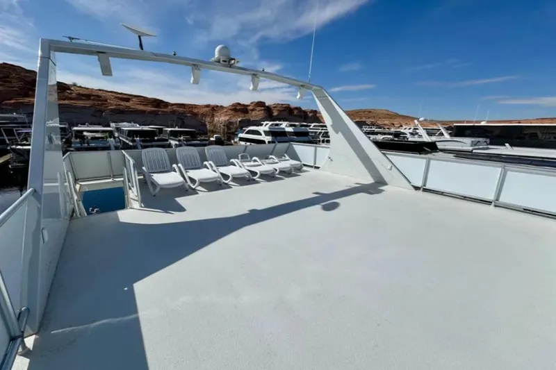 Slide: The Image of Spacious deck of 2012 Bravada Helios Trip #7 houseboat with lounge chairs and scenic marina view. - 29