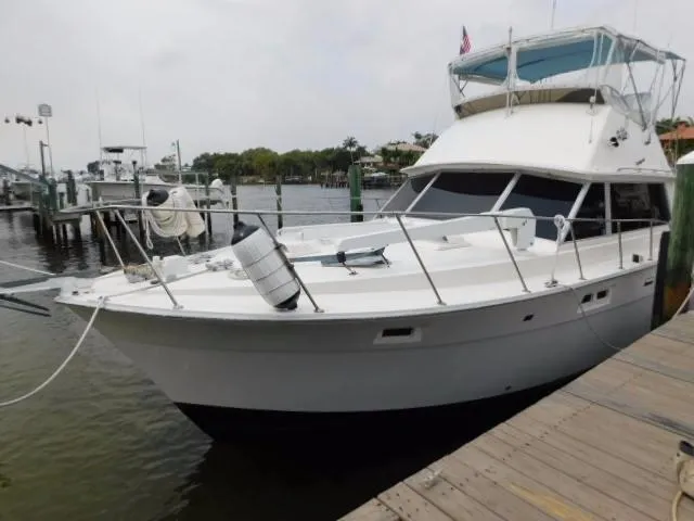 The Image of 1976 Bertram 42 Convertible yacht docked at marina, featuring classic design and spacious deck. - 1