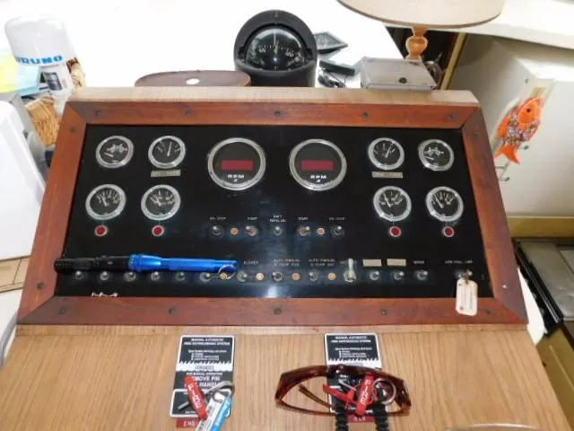 Slide: The Image of Control panel of a 1976 Bertram 42 Convertible boat with gauges and switches. - 11