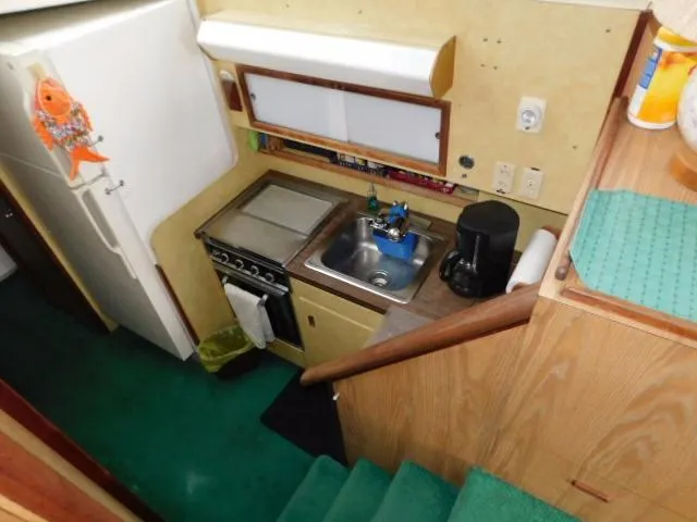 Slide: The Image of 1976 Bertram 42 Convertible galley with stove, sink, and refrigerator. - 16