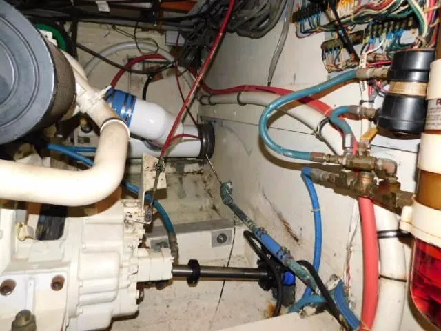 Slide: The Image of Engine room of a 1976 Bertram 42 Convertible with visible wiring and piping. - 25