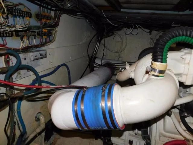 Slide: The Image of Engine room of a 1976 Bertram 42 Convertible with visible pipes and wiring. - 26