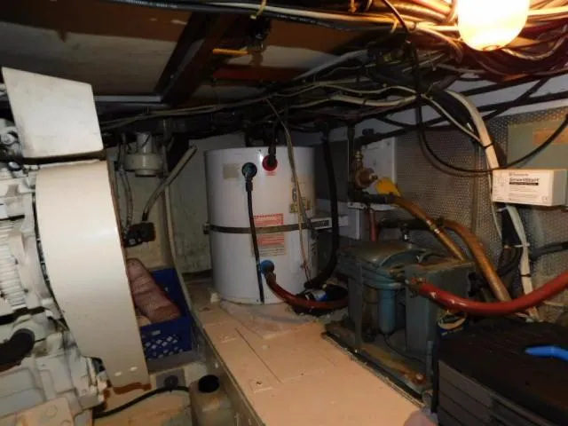 Slide: The Image of Engine room of a 1976 Bertram 42 Convertible boat with visible machinery and wiring. - 28