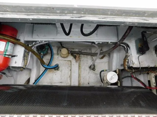 Slide: The Image of Engine compartment of a 1976 Bertram 42 Convertible boat, showing hoses and equipment. - 3