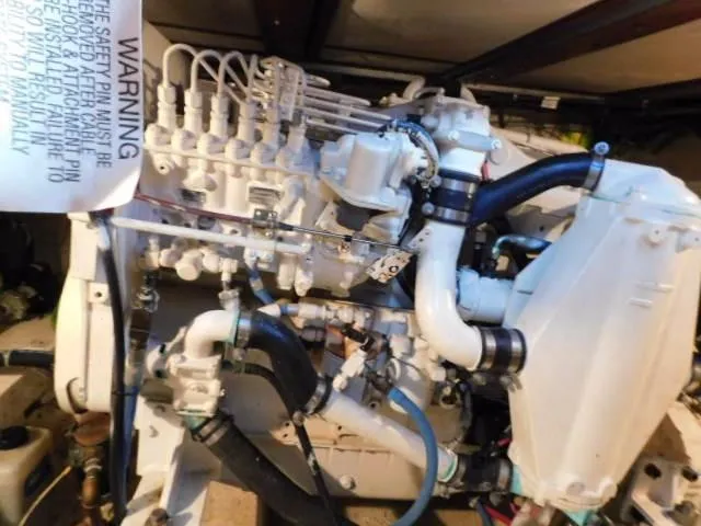 Slide: The Image of Engine of a 1976 Bertram 42 Convertible boat, showcasing intricate mechanical components. - 30