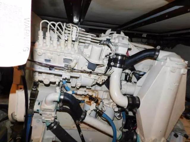 Slide: The Image of Engine compartment of a 1976 Bertram 42 Convertible boat, showcasing mechanical components. - 31