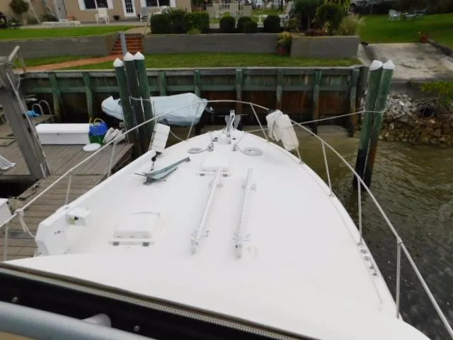 Slide: The Image of 1976 Bertram 42 Convertible boat docked at a marina, view of the bow. - 35
