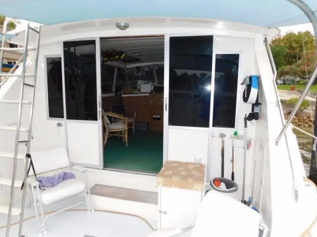 Slide: The Image of 1976 Bertram 42 Convertible yacht interior with open sliding doors and fishing gear. - 5