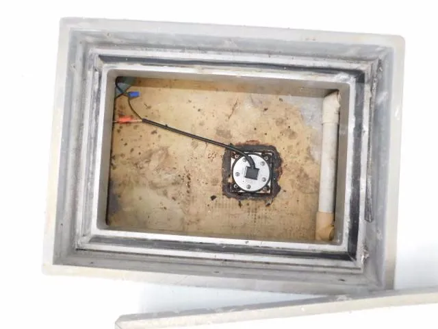 Slide: The Image of Open compartment in 1976 Bertram 42 Convertible boat, showing wiring and pipe. - 6