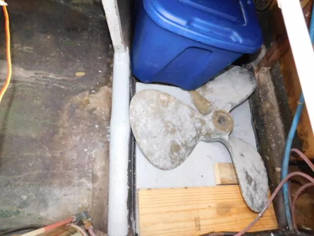 Slide: The Image of 1976 Bertram 42 Convertible boat propeller and blue storage bin in cabin area. - 7