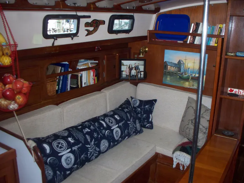 Slide: The Image of Interior of 1983 Whitby 42 sailboat with cozy seating and nautical decor. - 14