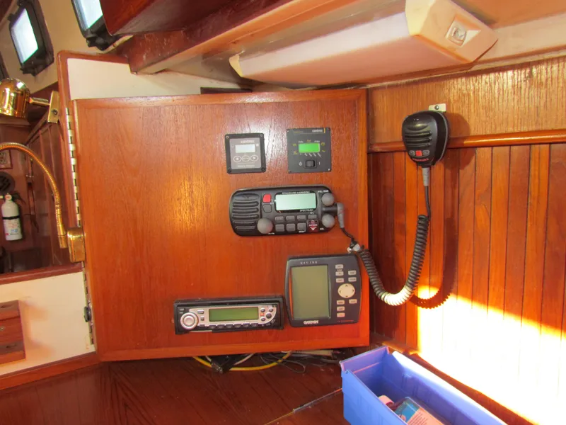 Slide: The Image of Control panel of a 1983 Whitby 42 sailboat with navigation and communication equipment. - 17