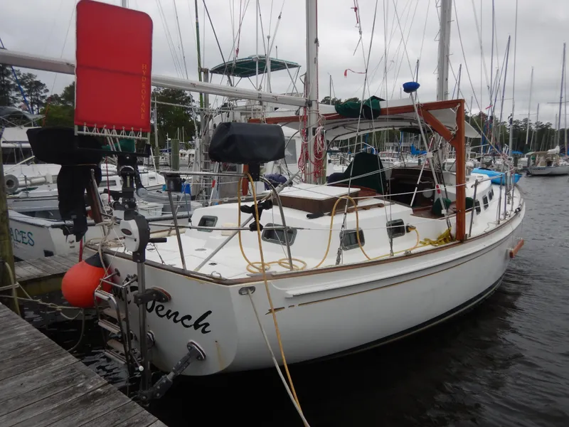 Slide: The Image of 1983 Whitby 42 sailboat docked at a marina on a sunny day. - 2