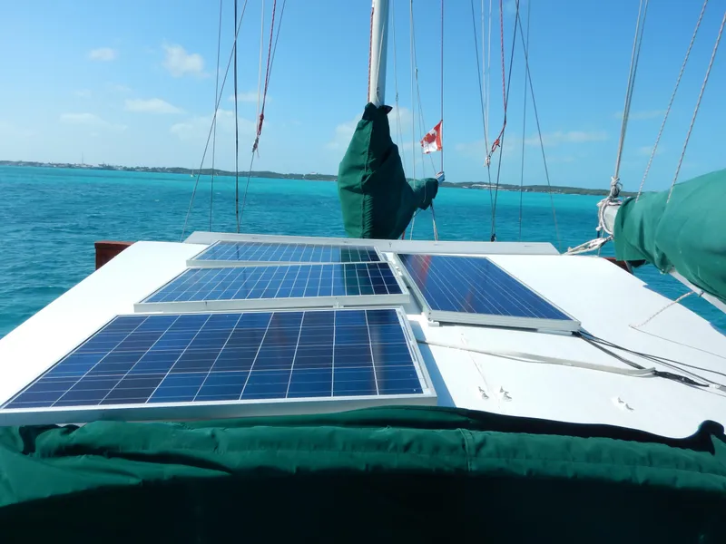 Slide: The Image of Solar panels on a 1983 Whitby 42 sailboat in turquoise waters. - 9